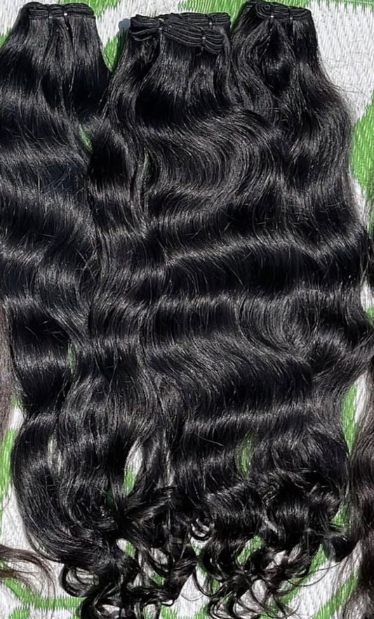 Black hair extensions on a textured green and white background